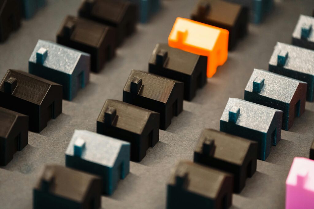Close-up of colorful 3D model houses showcasing real estate concepts with a vibrant standout piece.